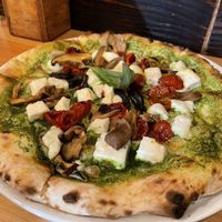 Vegan pizza with pesto, vegan cheese, dry tomatoes and mushrooms.  at Cheese & Tomatin in Inverness