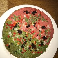 Raw pizza, half marinara and half pesto  at Peacefood Cafe - Uptown in New York City