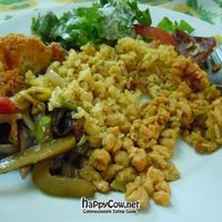 Lunch plate, with fried corn fritter, rice, TVP, Thai stir fry, salad, and fake meat. at Girasoles Restaurante Vegetariano in Cartagena