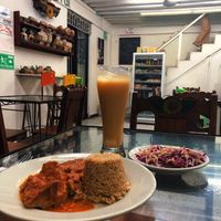 Chickpea Mole with veggie rice, Pineapple rice juice, and a side salad at Girasoles Restaurante Vegetariano in Cartagena
