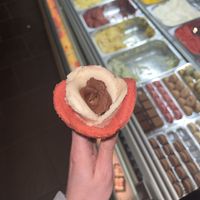 Chocolate, banana and strawberry sorbet in a cone.  at Amorino - Carmelitas in Porto