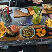 Papadam with hummus, vegan burger, edamame, fried cauliflower, french fries at Pincho Nation in Copenhagen