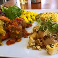 All main 3 dishes of the day on one plate. Rice with mango, tofu in different variations with tamarind sauce, lentils, caramelized apples and salad. at M Butterfly by Miss Saigon in Lisbon