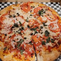 THE SCREAMIN' TOMATO with Daiya cheese hiding the balsamic glaze. at Extreme Pizza in Myrtle Beach