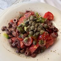 Dakos Cretan salad with barley, cherry tomatoes, green peppers, olives and capers.  at Gods' Restaurant - Οινομαγειρείο των Θεών in Athens