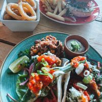 Tacos & vegan burger in the background. Vegan onion rings 🌱  at The Slope in Newquay
