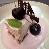 Cherry cheesecake on a bottom of dates and nuts, with cherry saus, yoghurt ice cream and chocolate   at De Levensboom in Hasselt