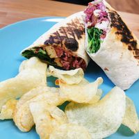 Crispy tofu toasted wrap with crisps. #vegan at Peacock Cafe in Stanmore