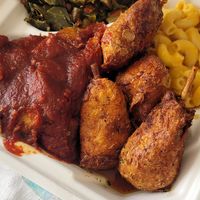 Plate with lemon pepper wings and brisket at Vegan Mob in Oakland