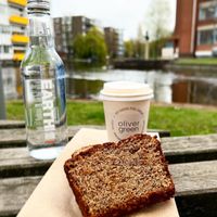 To-Go; Banana Bread, cappuccino with sprout milk and water   at Oliver Green - East in Amsterdam