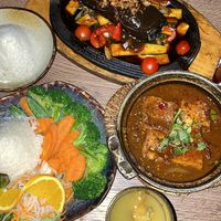 Top: Cha Ca (Marinated tofu with oyster mushrooms wrapped in seaweed sheets, tomatoes, zucchini, dill and spring onions, refined with lemongrass and galangal. Served with rice).  at Soy in Munich