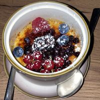 Banh Kem Dua - Creme Bruleé made from vanilla | coconut with a slightly sweet ginger-agave sauce | fruit mix  at Soy in Munich