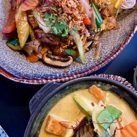 Stir-fried flat rice noodles with seitan and veggies, and a homemade curry with tofu and udon noodles at Soy in Munich