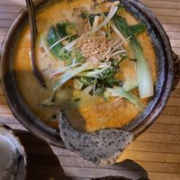 vegan soup with coconut milk, curry and vegetables with a sesame rice cracker  at Soy in Munich