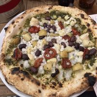 PIZZA V1 basil pesto, vegan cheese, red semi dried tomatoes, cauliflower, olives & potato  at Sano in Dublin
