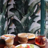 A selection of our favorite vegan dishes and drinks: soymilk latte, aromatic tea, Avo toast, Açaí Bowl, and a toast with homemade almond butter and banana. at So Acai in Guangzhou