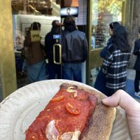 Vegan slice outside Scarr’s  at Scarr's Pizza in New York City
