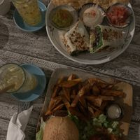 Our order - meaty mushroom burger with sweet potato fries and salad and the bean burrito with nachos at Sacred Lotus Cafe in Phnom Penh