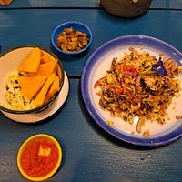 Fried chickpea tofu with tomato turmeric sauce, pickles, Burmese green tea leaf salad  #Veganuary at Free Bird Cafe in Chiang Mai