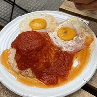 Vegan fried eggs with rice and tomato sauce  at Veganitessen in Sevilla