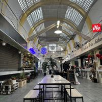 Tables in the market (next to the counter)  at Veganitessen in Sevilla