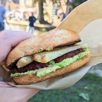 Smashed avo, vegan halloumi & sundried tomato bagel at The Den in Bourton-on-the-water