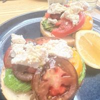 Bagel with avocado, tomatoes and feta  at Oh My Days in Glebe