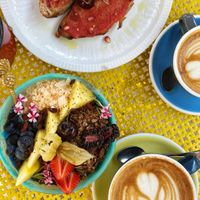 Blue tooth smoothie bowl, latte with oat milk, toasts with tomato paste  at Mama Carmen's Coffee & Bakery in Mallorca
