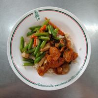 Tofu, green pea and carrot stir fried with red curry faux pork topping on steam rice. at Welfare Cafeteria - Kiosk 27 in Bangkok