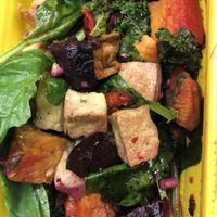 A DIY bowl with kale, rice, roasted mushrooms, beets, sweet potatoes, peppers, and tofu, with a miso sesame dressing (all of the dressings are vegan)   at Martha's Cafe in Ithaca
