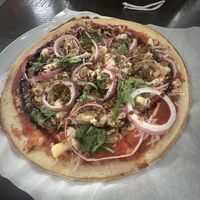 Gluten free crust with red sauce, plant based cheese and sausage, onion, pineapple, mushroom, and balsamic glaze, quite good!  at Mod Pizza in Sierra Vista