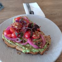 Smashed avo toast - sourdough, avo, pickled onion tomato, dukkah and microherbs ($14 Oct 2023) at Grit Cafe in Goulburn