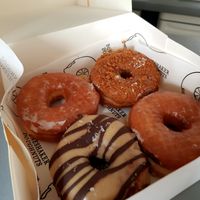 Regular, banana cream pie special, peanut/ chocolate at Boneshaker Doughnuts in Paris