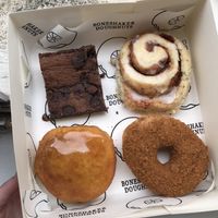 Different selection of foods at Boneshaker Doughnuts in Paris