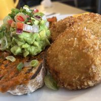 Avo on sourdough with breaded fried green tomatoes   at The Breakfast Club in East London
