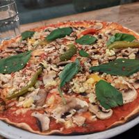Vegan pizza with little vegan cheese crumbs at Il Forno in Stockholm