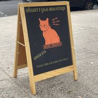 Cute sign; Baristas wear masks; many customers outside did wear them to order too but not all  at Mighty Oak Roasters in Astoria