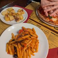 Penna alla primavera forefront and bakes potatoes to the left. at La Grotta Di Leo in Florence
