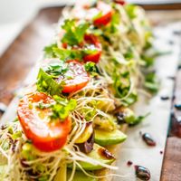 Avocado, artichoke hearts, kalamata olives, clover sprouts, tomatoes, cherry peppers, roasted garlic, cilantro, olive oil at Journey Cafe in Kailua Kona