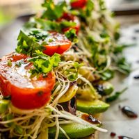Avocado, artichoke hearts, kalamata olives, clover sprouts, tomatoes, cherry peppers, roasted garlic, cilantro, olive oil at Journey Cafe in Kailua Kona