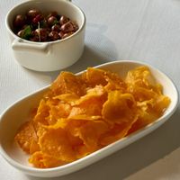 Sweet potato chips and peanuts with herbs  at JOMNO Modern Khmer Cuisine  in Siem Reap