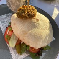 Pita falafel with tomatoes, pickles, mint and parsley. Specify vegan when ordering bc it normally comes with a yoghurt dressing that isn’t written down on the menu at Van der Valk in Goes