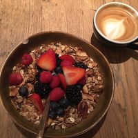 granola with soy coconut joghurt and fresh berries and flat white with oat milk  at Koffiespot in Amsterdam