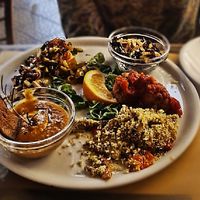  Vegan Sunday lunch (half eaten!) includes : black rice salad , mixed vegetables on a noodle “nest”, soy patties in tomato sauce, cold pumpkin soup with rosemary, breaded mushr at A Putia Dell'Ostello in Catania