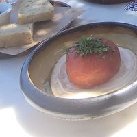 Homemade foccacia with extra virgin olive oil from their farm and Tomato 'Gemista' filled with quinoa, mint, raisins & side raita sauce at Med Cafe in Crete