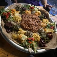 4 different vegan meals put on one big plate   at Lalibela in Berlin