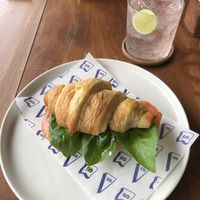 Croissant with pesto, tomato and vegan Camembert and homemade rosella lavender lemonade   at Secret Spot - Canggu in Canggu
