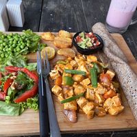 Tofu with salad, fresh peas roasted potatoes, salad and guacamole. at Little Windows in Pokhara