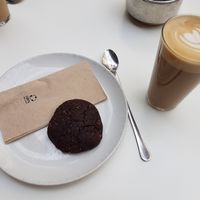 Cafe latte with oat milk and vegan chocolate cookie at Federal Cafe in Barcelona