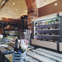 Modern interior, fridges with many ready made salads packaged in plastic at Cuore Fresco in Catania